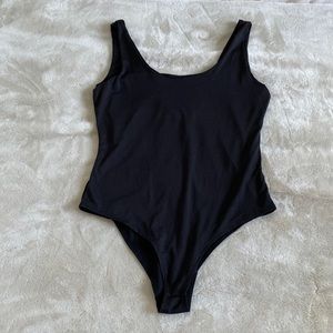Black body suit. Dri-fit like material. Never worn! No tags. Super soft. Size S